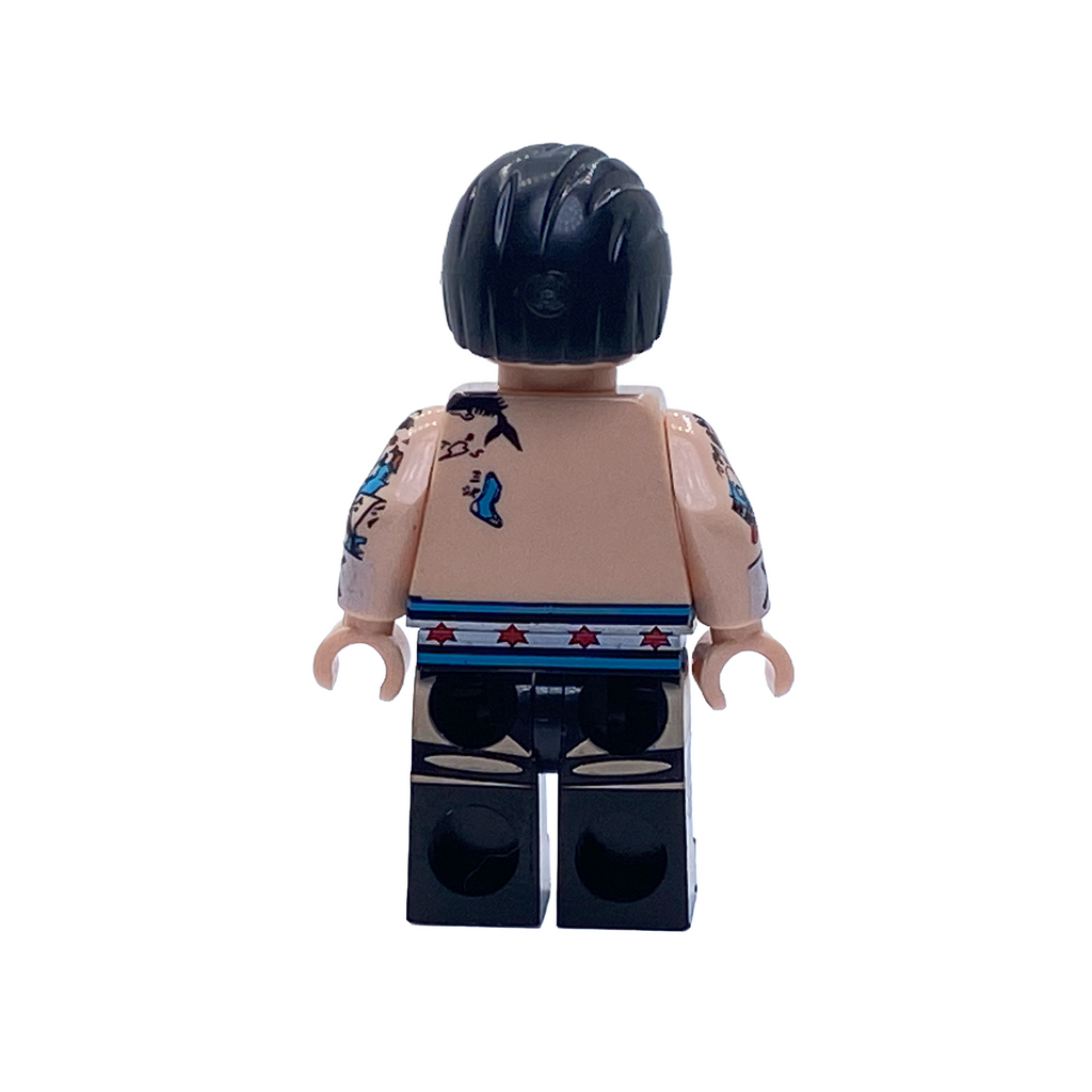 Rear view of the CM Punk WWE custom minifigure showing black hair, back and arm tattoos and blue-and-white ring gear.
