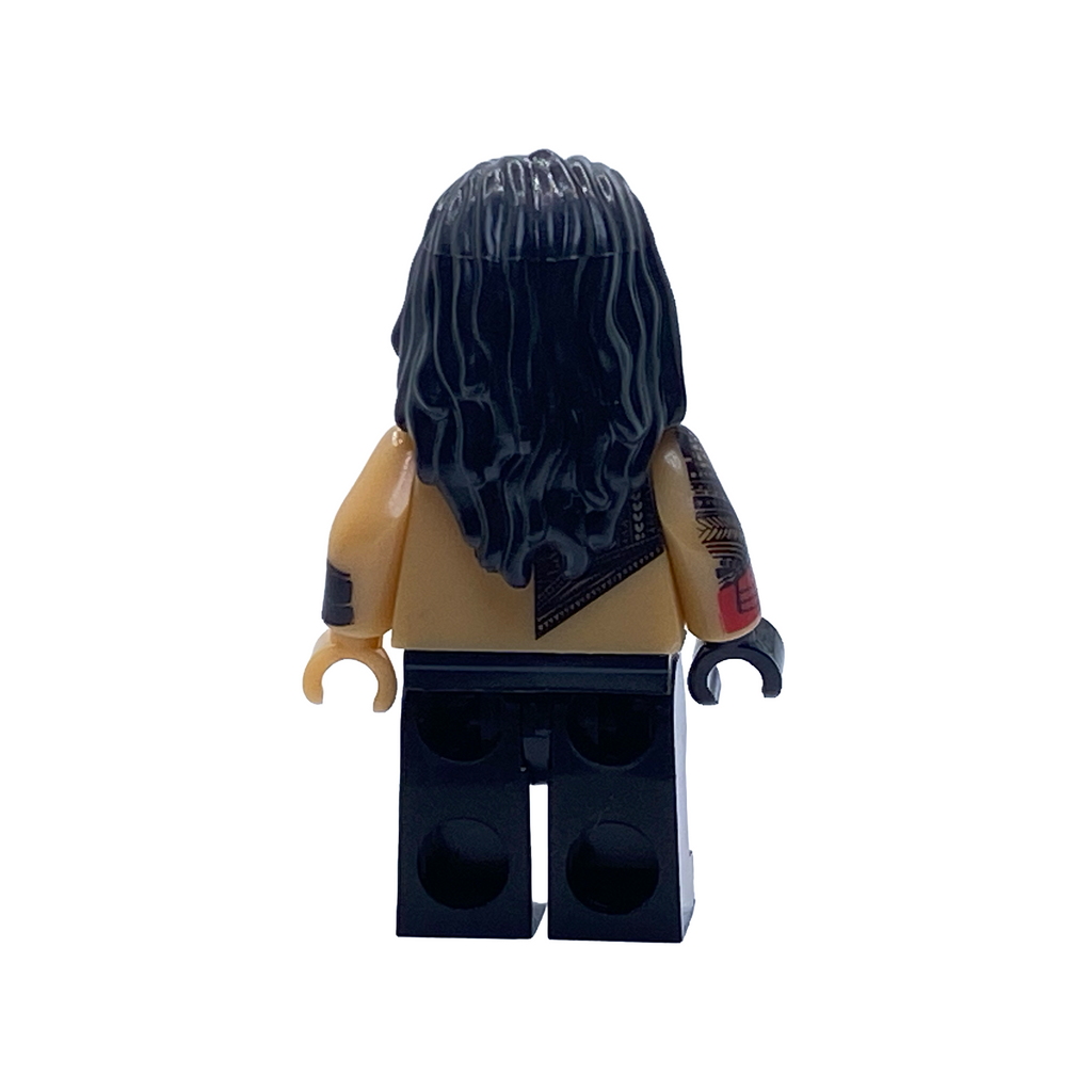 Rear view of the Roman Reigns WWE custom minifigure showing long black hair, tattooed arm, red glove and black ring trousers.