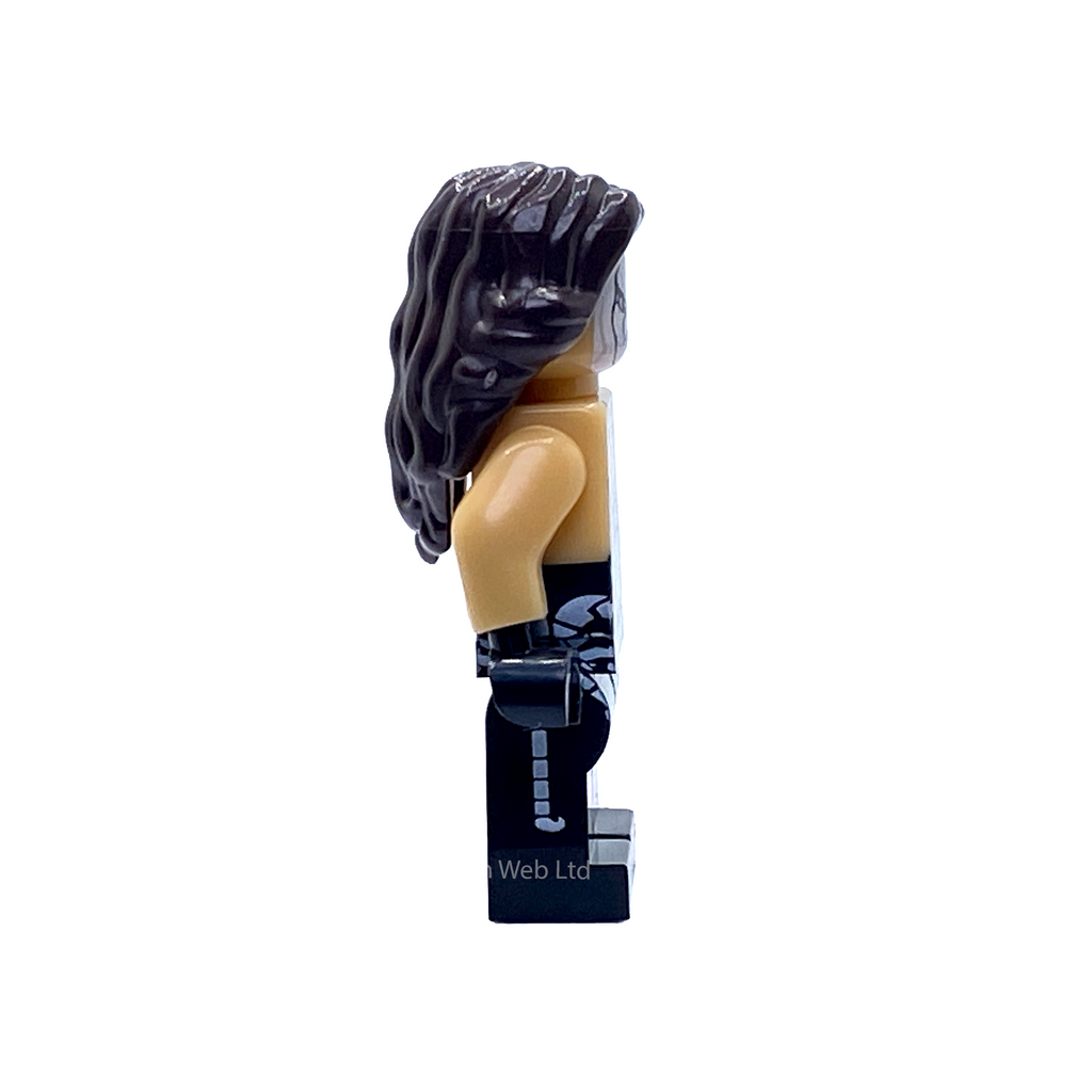 Side profile of the Sting WWE custom minifigure showing long black hair, monochrome face paint and skull print on the black ring trousers.